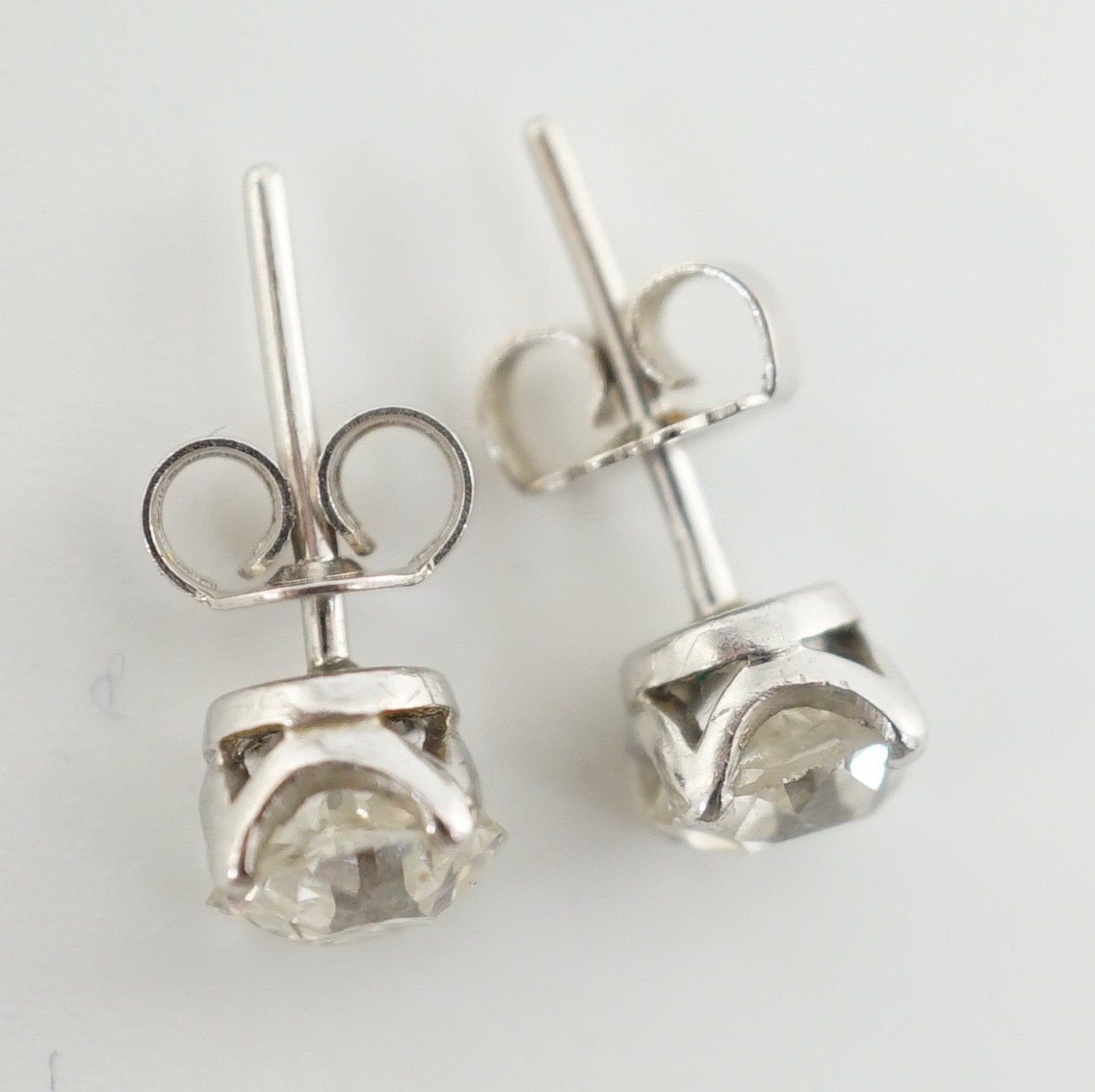 A pair of white gold? and solitaire diamond set ear studs